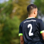 Rückenansicht eines Jugendlichen im Sporttrikot mit Rückenprint „TSV Enzweihingen“ und der Nummer 2, draußen vor unscharfem Grün.